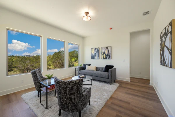 Upstairs sitting room with three picture windows overlooking Texas Hill Country ridgelines